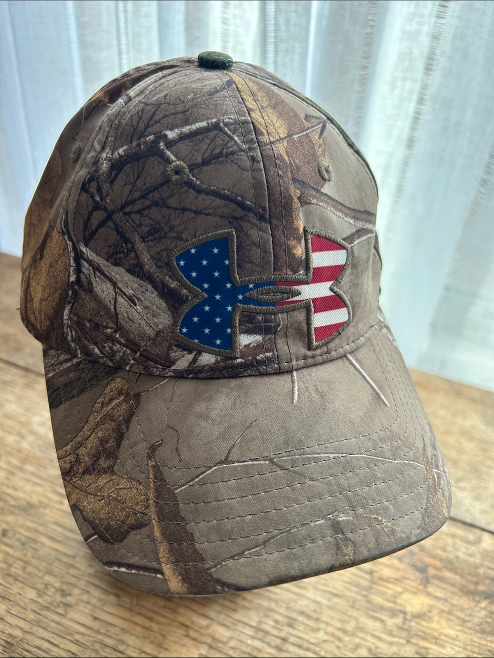 Under Armour-Real Tree Man’s Brown Camo Hat with American Flag Logo In Front.